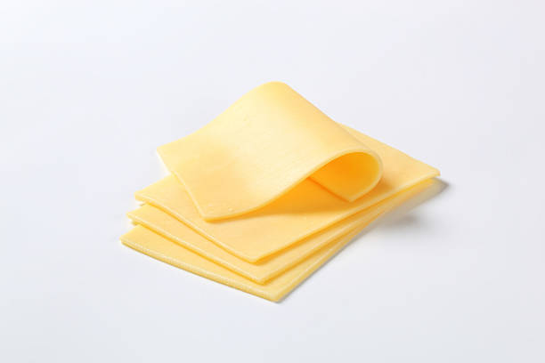 Four cut up slices of cheese isolated on a white background stock photo