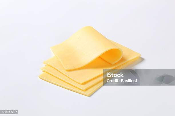 Four Cut Up Slices Of Cheese Isolated On A White Background Stock Photo - Download Image Now