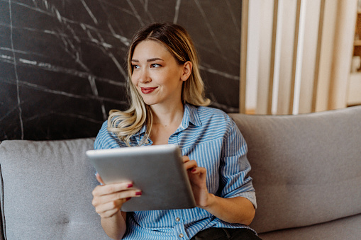 Young woman using her digital tablet