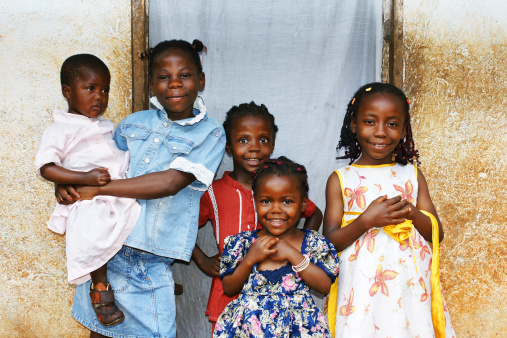 Real candid family photo of five cute and sweet black African sisters or girls, all smiling in their sunday dress, perfect for developing country and third world population issues. More people at: http://tonytremblay.com/sylvie/people.jpg