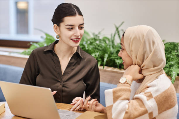 istock Two Middle Eastern businesswomen using laptop together in office 1631428118