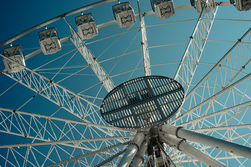 Ferris wheel and blue sky seen directly from below