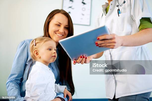 Doctor Showing Results On The Tablet Stock Photo - Download Image Now - Child, Baby - Human Age, Discussion