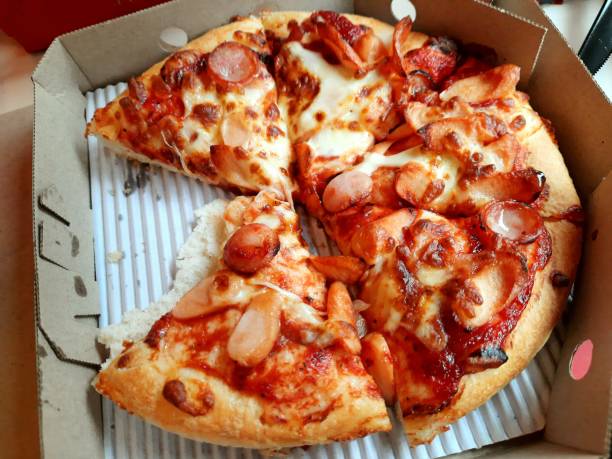 istock Eating Ham and Sausage Pizza. 1631465849