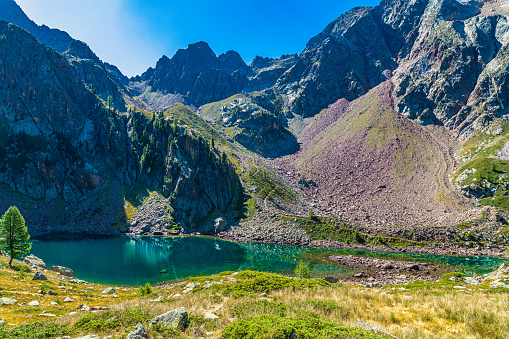 In the province of Cuneo, in southern Piedmont, lakes of glacial origin set on blood-colored rocks