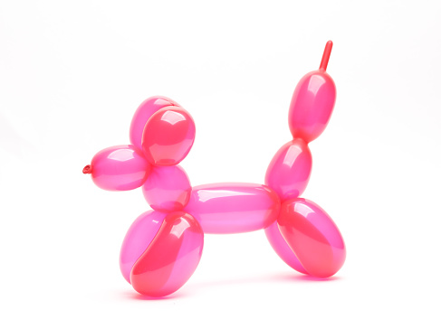 Inflatable pink balloon dog isolated on white