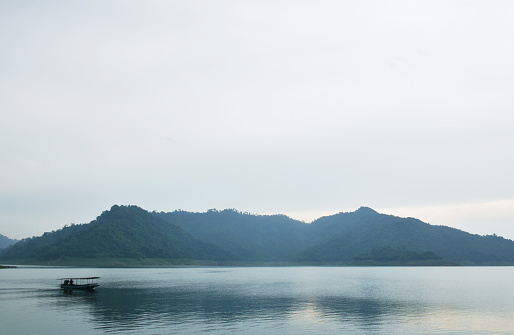 landscape of water reservoir lake with mountain background in sunset