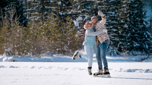 istock Young couple taking selfie on snow 1631511984