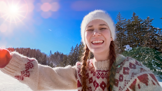 Portrait of smiling woman on frozen lake.