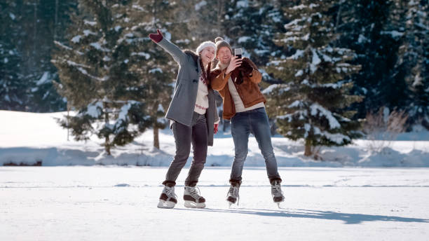istock Couple taking selfie on snow 1631512006
