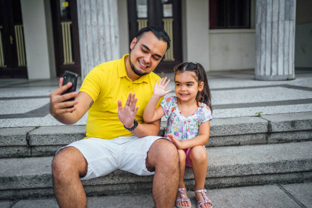 istock Father and daughter having a video call 1631525257
