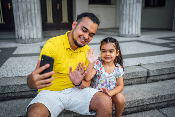 Father and daughter having a video call