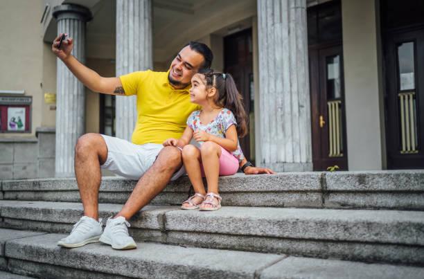 istock Father and daughter taking selfies 1631527514
