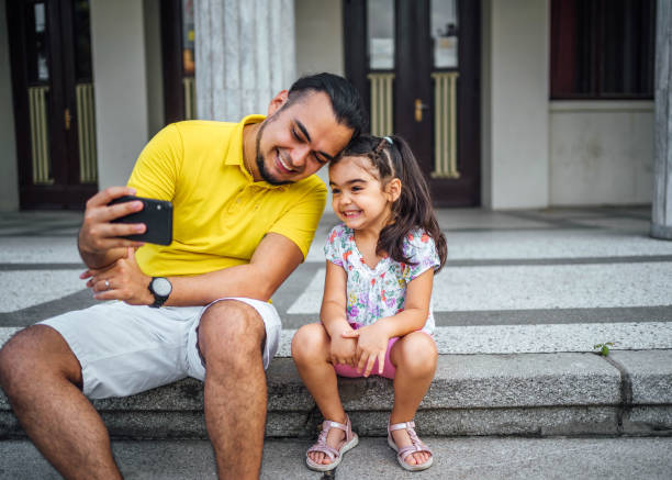 istock Father and daughter taking selfies 1631528621
