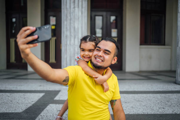 istock Father and daughter taking selfies 1631528642