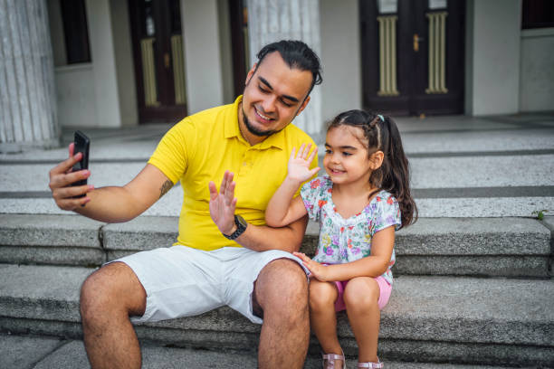 istock Father and daughter having a video call 1631529180
