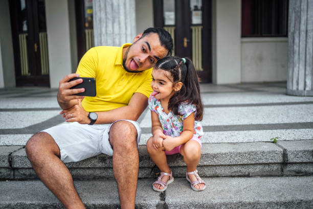 istock Father and daughter taking selfies 1631529213