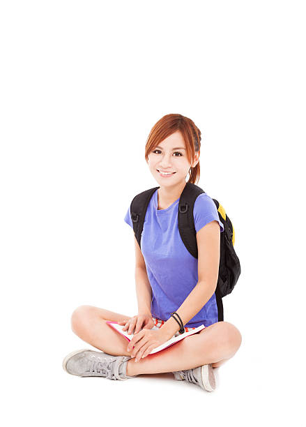 istock student girl reading book and sitting on floor 163154544