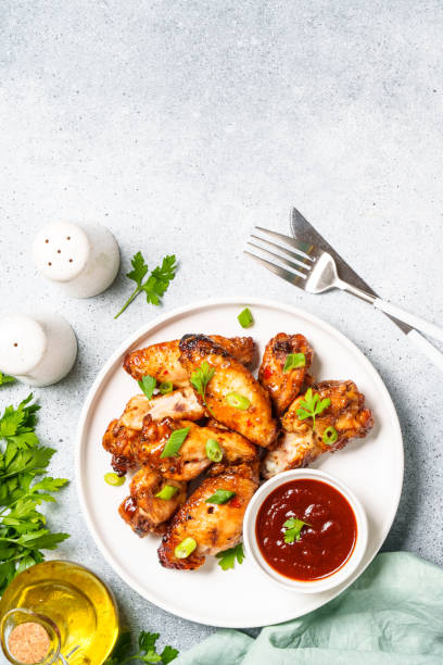 istock Chicken wings in bbq sauce at white table. 1631555391