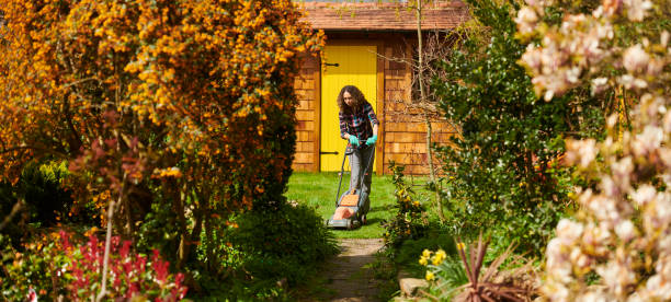 istock young woman mowing the lawn 1631592827