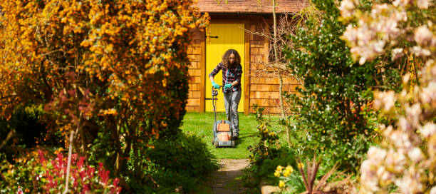 istock young woman mowing the lawn 1631595683