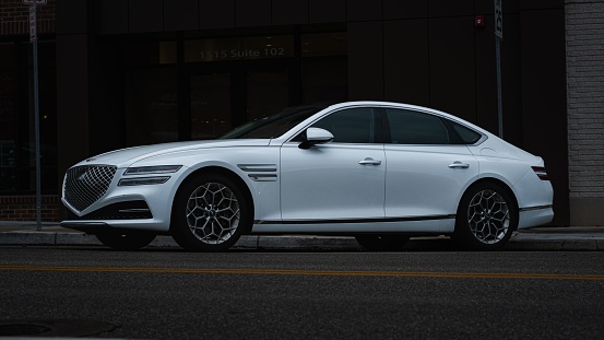 Tulsa, United States – August 20, 2022: A closeup of a white 2021 Genesis G80 with a dark background