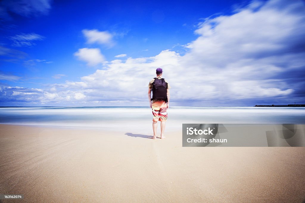 Traveller on the Beach A man with his backpack on the beach. Long exposure. 30-39 Years Stock Photo