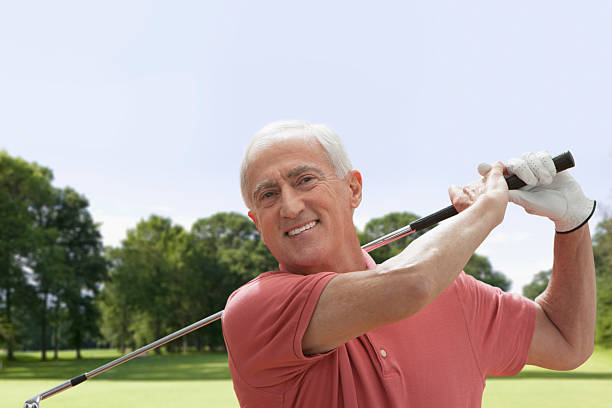 istock Smiling Senior man swinging golf club 163162703