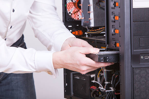 istock Closeup of computer engineer replacing hard drive in rack 163162788