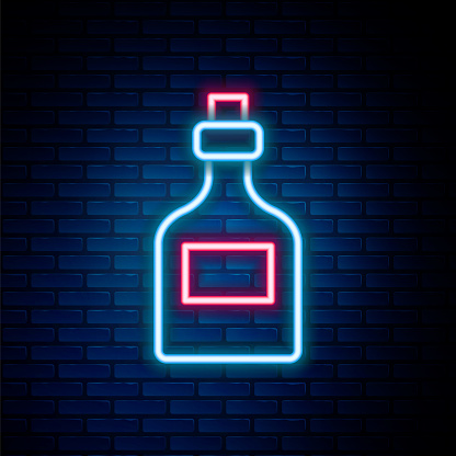 Glowing neon line Alcohol drink Rum bottle icon isolated on brick wall background. Colorful outline concept. Vector.