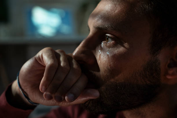 Depression Sad man crying in living room late at night. Depression concept. crying stock pictures, royalty-free photos & images