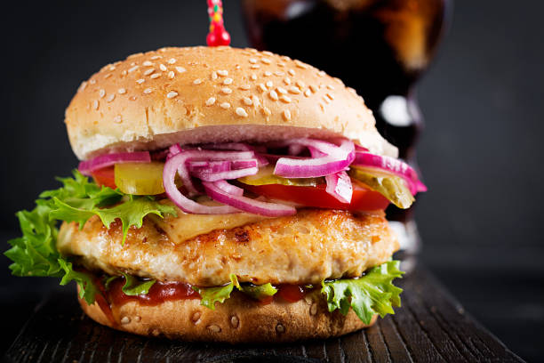 istock Chicken hamburger. Sandwich with chicken burger, tomatoes, cheese and lettuce. Cheeseburger. 1631661770