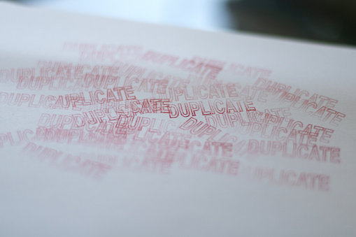 DUPLICATE red rubber stamp over a white background.