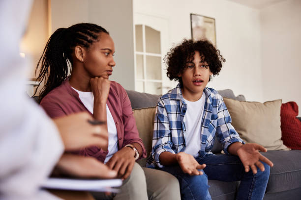 istock An African mother looking at her son while talking with the doctor during a home visit. 1631680971