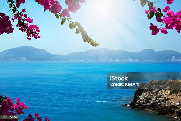 Flowers Framing Blue Sea Stock Photo - Download Image Now - Greece, Mediterranean Sea, Greek Culture