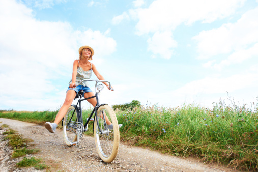 An attractive young woman enjoying riding her bicycle