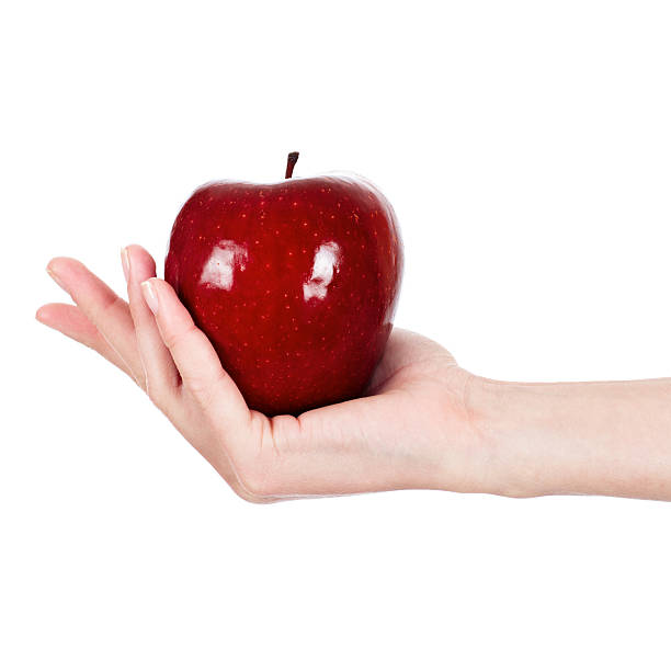 istock Red juicy apple in female hand 163175001