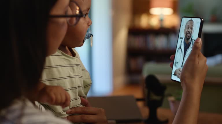 Phone, doctor and a mother with her baby in their home for virtual consulting with a medicine professional. Contact, medical and remote with a male pediatrician on a mobile display for healthcare