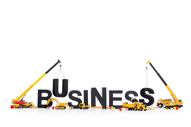 istock Build up a business: Machines building business-word. 163179100
