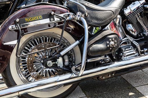 Motorcycle power transmission belt made of kevlar, shiny chrome, exhaust pipe, drive gear, motorcycle tuning.