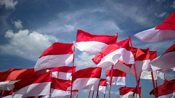 istock Many Indonesian red and white flag with blue sky background 1631797553