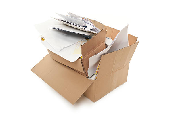istock Two stacked cardboard boxes overflowing with office papers  163181263