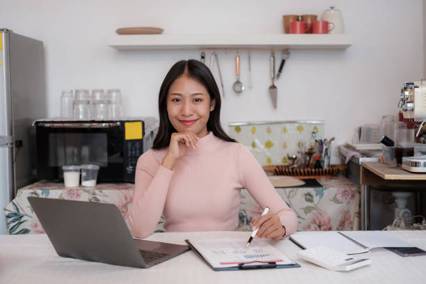 istock Beautiful Young Freelancer Lady Working With Laptop In Kitchen 1631821182
