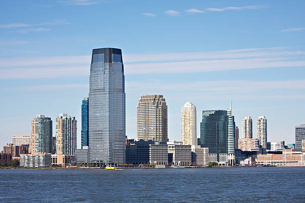 Jersey City skyline Jersey City skyline shot from Manhattan with Hudson River in foreground. jersey city stock pictures, royalty-free photos & images