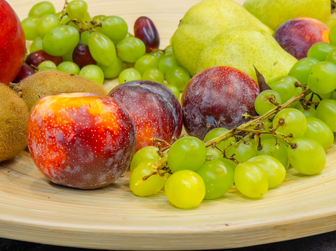 fruits plate with grapes, pears, apples, banana