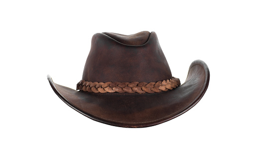 Viejo sombrero vaquero marrón de cuero aislado sobre fondo blanco photo