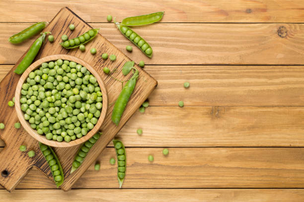 istock Composition with fresh green peas on wooden background, top view 1631860274
