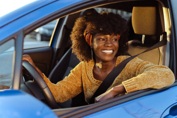 istock Cheerful female driver in the car 1631861262