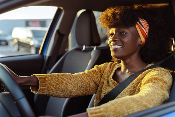 istock Cheerful female driver in the car 1631861263