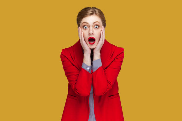 istock Amazed surprised woman with hands on cheeks, looking at camera with big eyes, sees something scary. 1631861405